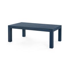 A deep navy Parsons coffee table with a grasscloth finish and a minimalist design, including stout lines and structured proportions.