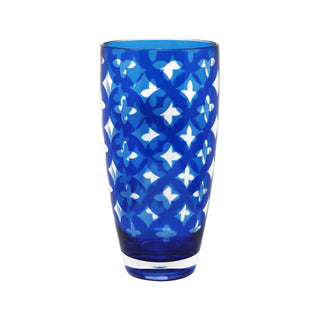Blue glass tumbler with white geometric pattern on a white background