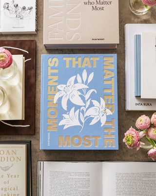 Collection of books on a wooden surface with floral decorations