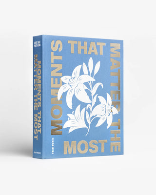 Book titled 'Moments That Matter The Most' with floral design on a white background