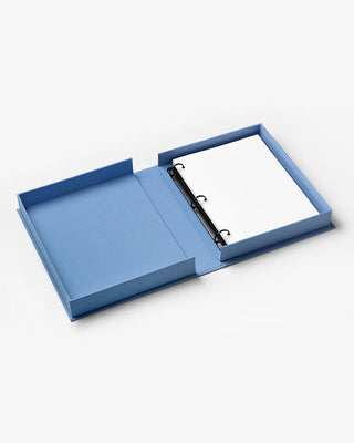 An open blue ring binder notebook with blank white pages and a black metal ring, photographed on a clean white background.