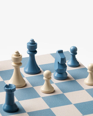 Blue and white chess pieces on a checkered blue and white chessboard
