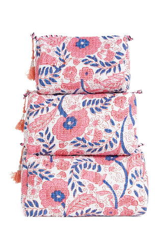 Set of three floral-patterned bags with tassels on a white background