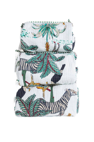 Stack of baby blankets with animal and leaf patterns on a white background