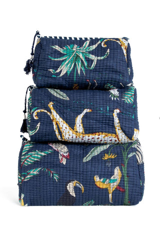 Set of three navy blue packing cubes with animal and leaf pattern on a white background