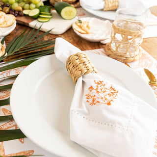 rattan natural napkin rings displayed holding a napkin on a plate