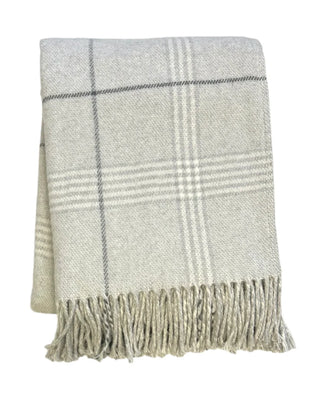 Plaid blanket with fringes on a white background