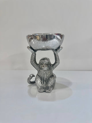 Silver monkey figurine holding a bowl on a white background