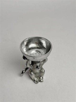 Silver candle holder with bear design on a light gray background