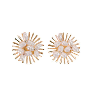 A pair of pearl stud earrings with a sunburst design and gold hardware.