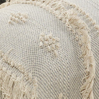 Textured pillow with decorative stitching and tassels on a neutral background