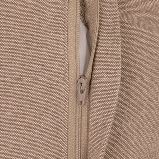 Close-up of a beige zippered garment showing the textured fabric, zipper pull, and inner lining.