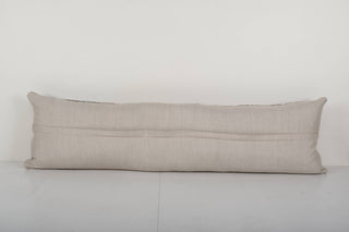 The vintage rug pillow has a plain canvas backing with zipper.