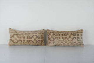 Rectangular vintage Turkish pillows with tan and pink geometric patterns are one-of-a-kind