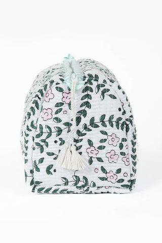 A white cotton drawstring pouch decorated with a green leaf and pink flower pattern, featuring two cream tassels at the top and bottom, set against a plain white background.