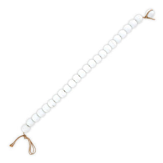 White beads with gold closure on a white background