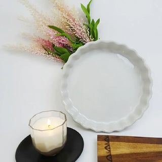 White ceramic pie and tart plate with scalloped edge makes it the perfect vessel for baking and serving