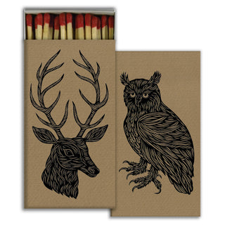 A set of brown kraft-paper matchboxes with black line-art illustrations of a deer head and an owl, with red-tipped matches visible in one box, shown on a white background.