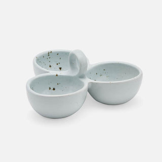 Three small ceramic cups with integrated handles, arranged in a triangular grouping, in a pale icy blue color with dark brown speckles, on a light gray background.