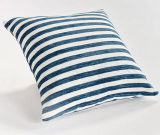 Striped blue and white pillow on a light gray background