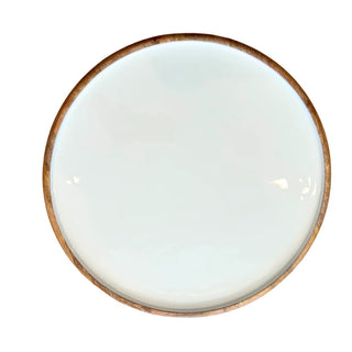 Round ceramic plate with a brown rim on a white background