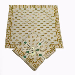 Set of four Mustard Sprig hand block print cotton napkins with a mustard yellow botanical pattern and decorative border